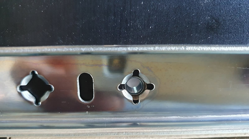 The pre-drilled hole with the t-nut (pressed in from the other side) for fastening the drawer to the rail