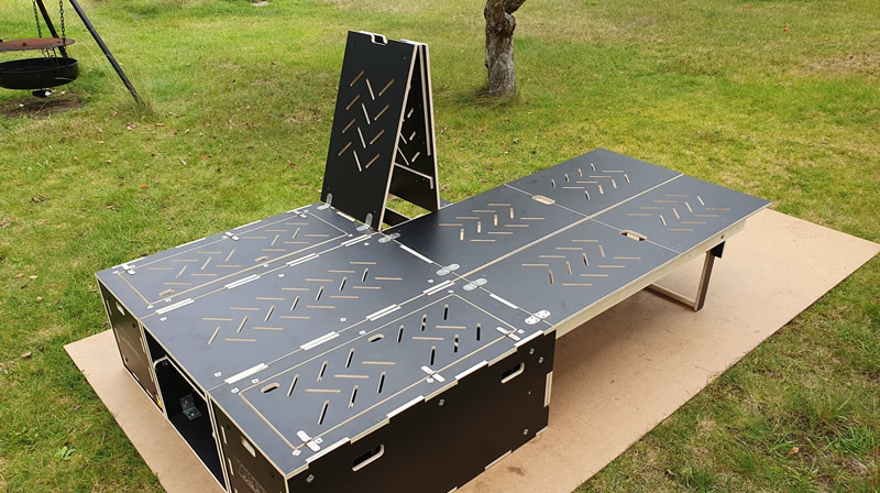 A 3 module camping box with one module in sofa mode and the other two in sleeping mode